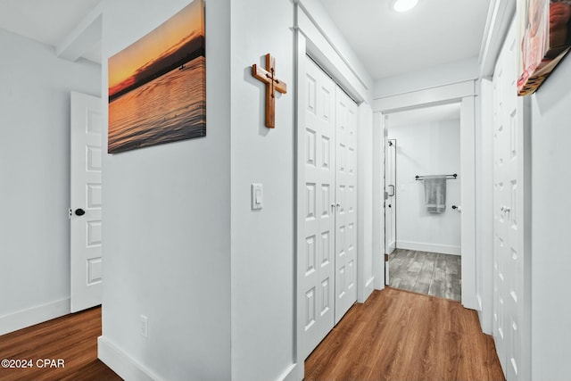 hallway with hardwood / wood-style flooring