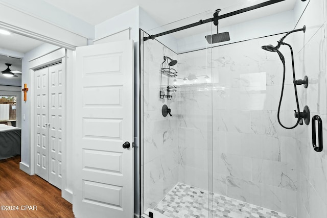 bathroom with wood-type flooring and an enclosed shower