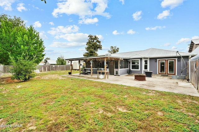 back of property with a yard, french doors, and a patio