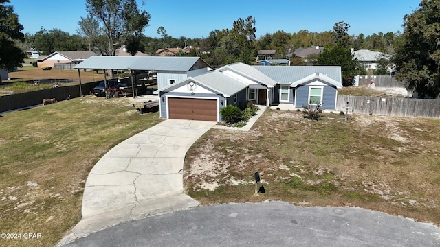 ranch-style home featuring a garage, a front yard, and a carport