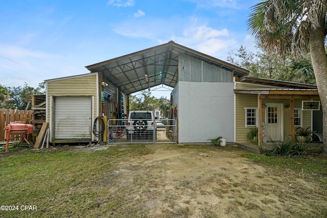 view of outbuilding featuring a garage and a carport