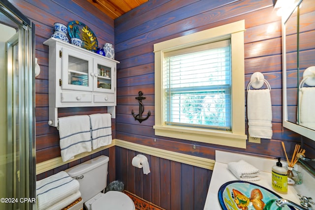 bathroom with wooden walls and toilet