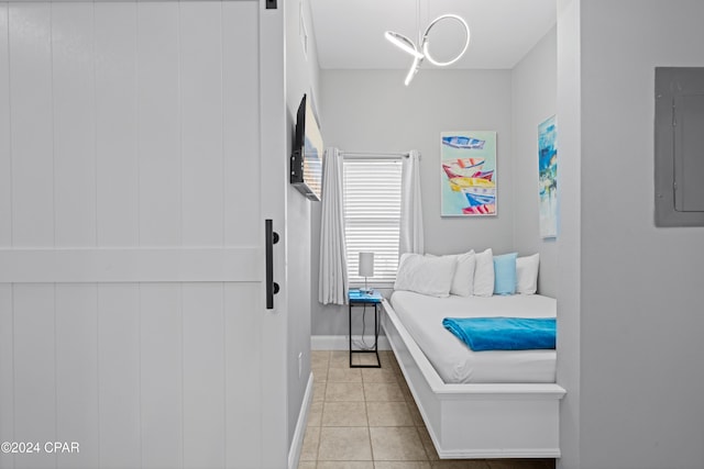 bedroom with light tile patterned floors and electric panel