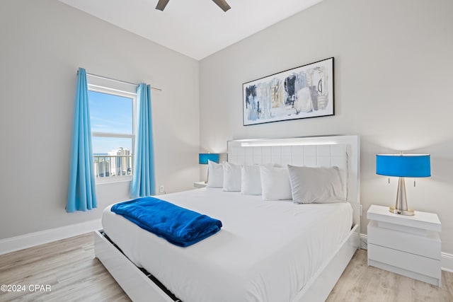 bedroom with light hardwood / wood-style floors and ceiling fan