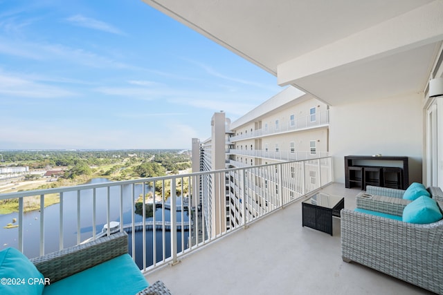 balcony featuring an outdoor hangout area and a water view