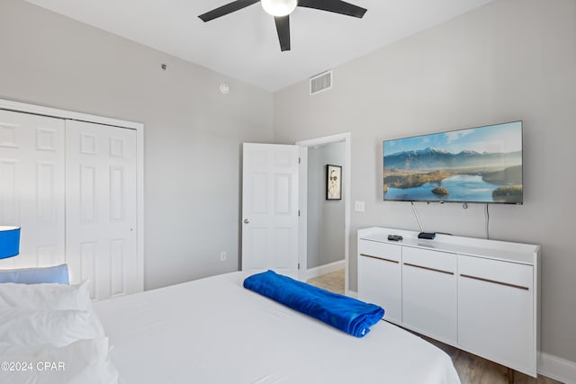 bedroom featuring ceiling fan, a closet, and light hardwood / wood-style floors