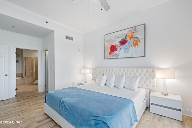 bedroom with ensuite bath, ceiling fan, light hardwood / wood-style floors, and ornamental molding