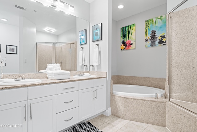 bathroom with tile patterned floors, vanity, and shower with separate bathtub