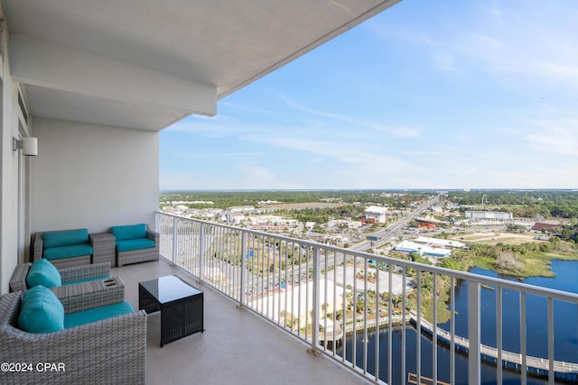 balcony featuring outdoor lounge area and a water view