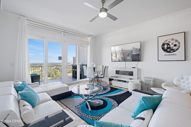 living room featuring crown molding and ceiling fan