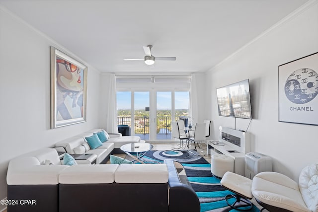 living room with ceiling fan and ornamental molding