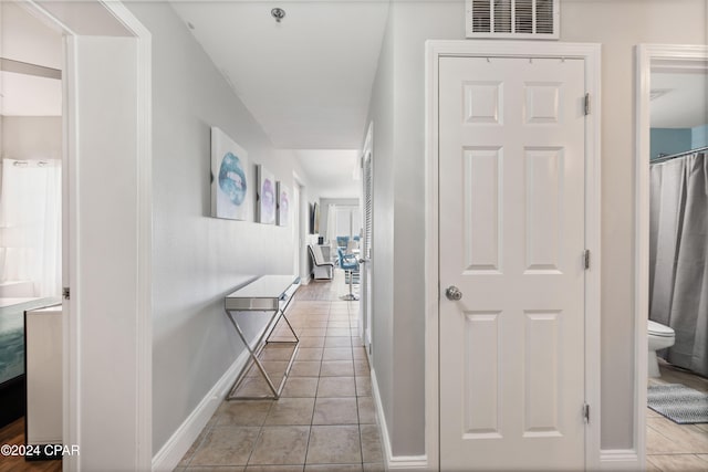 corridor featuring light tile patterned floors