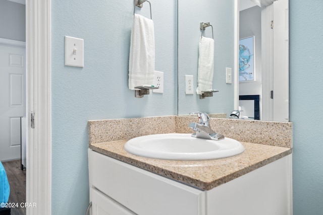 bathroom with hardwood / wood-style floors and vanity