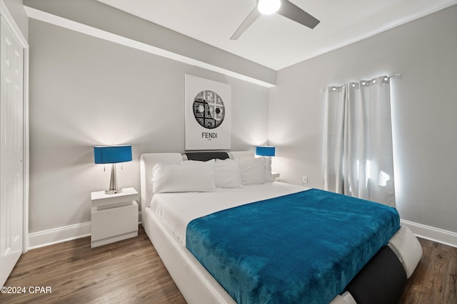 bedroom featuring ceiling fan and dark wood-type flooring