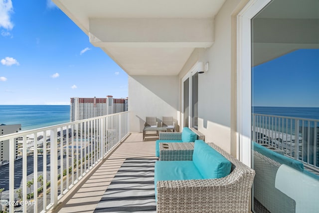 balcony with a beach view, a water view, and an outdoor hangout area