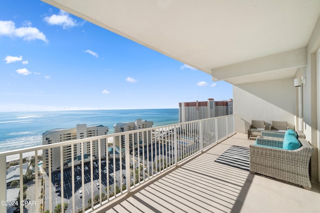 balcony featuring a water view and a beach view