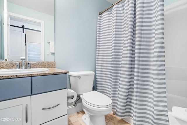 bathroom featuring toilet, vanity, and tile patterned floors