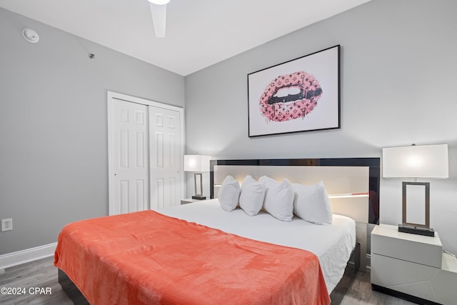 bedroom with ceiling fan, dark hardwood / wood-style flooring, and a closet