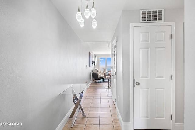 hallway featuring light tile patterned floors