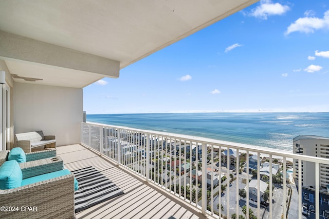 balcony featuring a water view and a beach view