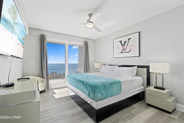 bedroom with access to exterior, ceiling fan, a water view, and light hardwood / wood-style flooring