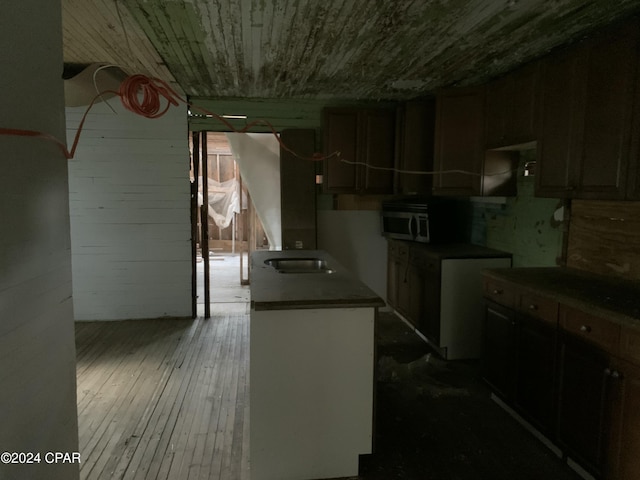 kitchen featuring stainless steel microwave, hardwood / wood-style floors, and wooden ceiling