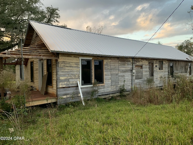 rear view of property with metal roof and a deck