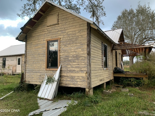 view of property exterior featuring metal roof