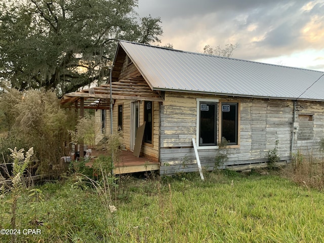 rear view of property with a wooden deck and metal roof
