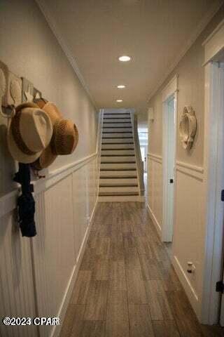 hallway with crown molding and dark hardwood / wood-style floors