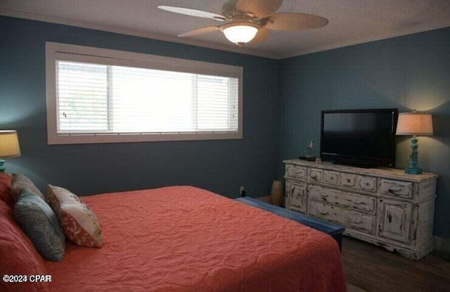 bedroom with ceiling fan, crown molding, and hardwood / wood-style flooring