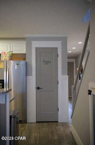 interior space featuring crown molding and dark hardwood / wood-style flooring