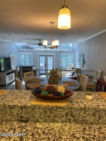 interior space featuring a chandelier, french doors, hardwood / wood-style flooring, and ornamental molding