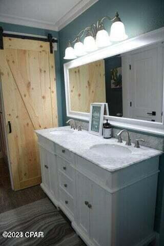 bathroom featuring vanity and ornamental molding