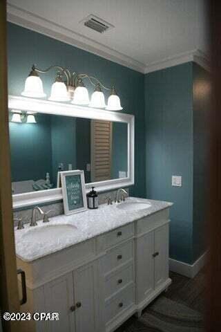 bathroom featuring vanity and ornamental molding