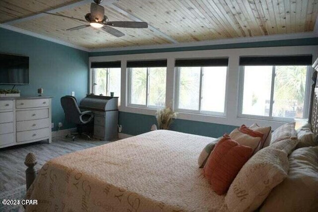 bedroom featuring ceiling fan, ornamental molding, and wood ceiling