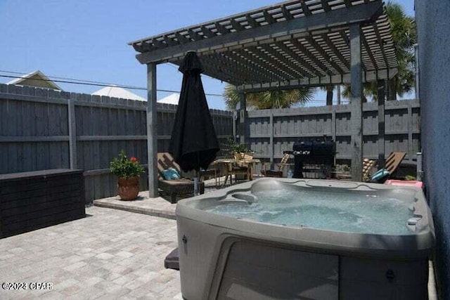 view of patio / terrace featuring a pergola and a hot tub