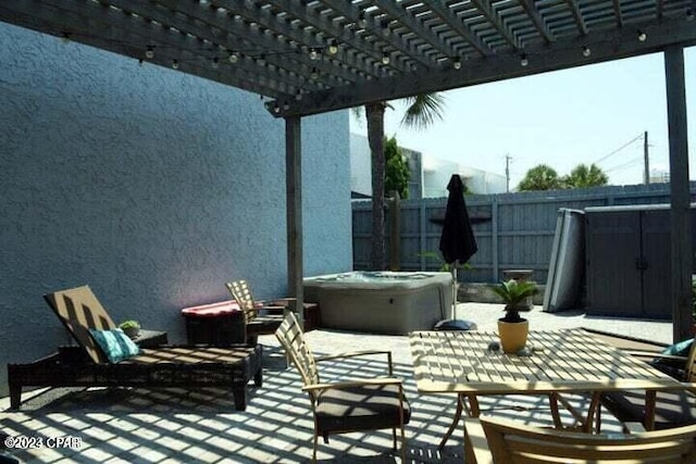 view of patio / terrace featuring a pergola and a hot tub