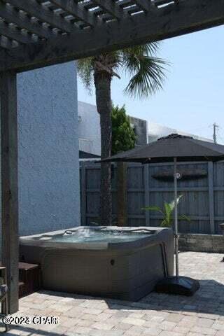 view of patio featuring a pergola and a hot tub