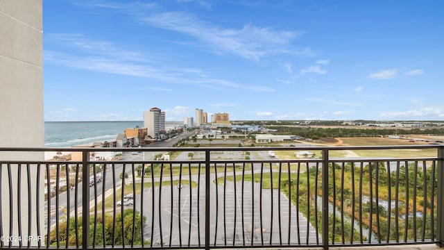 balcony featuring a beach view and a water view