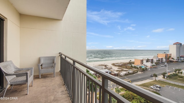 balcony featuring a water view and a view of the beach