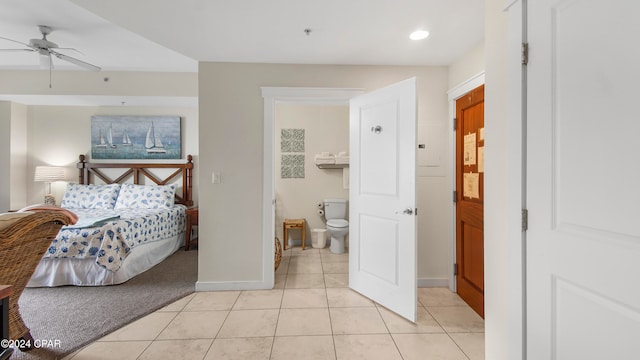 bedroom featuring connected bathroom, ceiling fan, and light tile patterned flooring