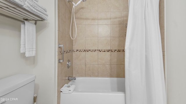 bathroom featuring shower / bath combination with curtain and toilet