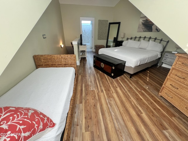 bedroom with dark wood-type flooring