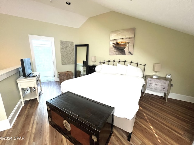 bedroom with dark hardwood / wood-style flooring and vaulted ceiling