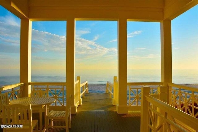 dock area with a water view and a view of the beach