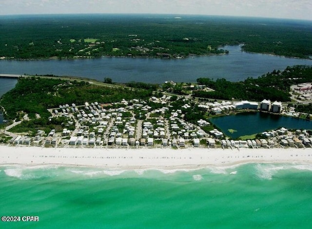 drone / aerial view featuring a water view and a view of the beach