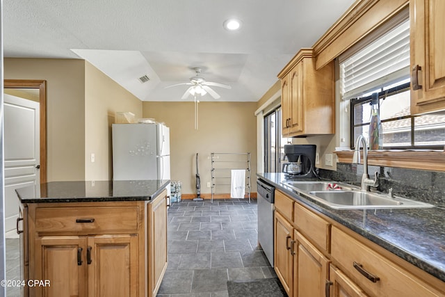 kitchen with ceiling fan, dishwasher, sink, a raised ceiling, and white fridge