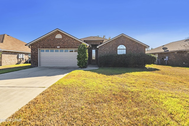 view of front facade with cooling unit, a front yard, and a garage