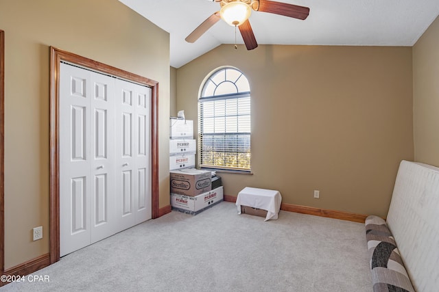 living area featuring light carpet, ceiling fan, and lofted ceiling